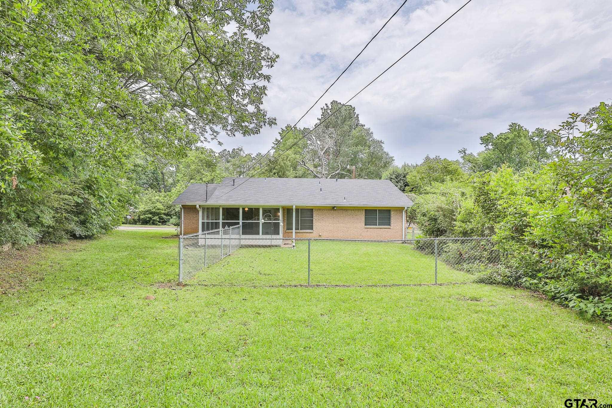 1707 Sampson Drive Tyler, TX 75701 - Photo 5 of 24 a view of a house with a backyard