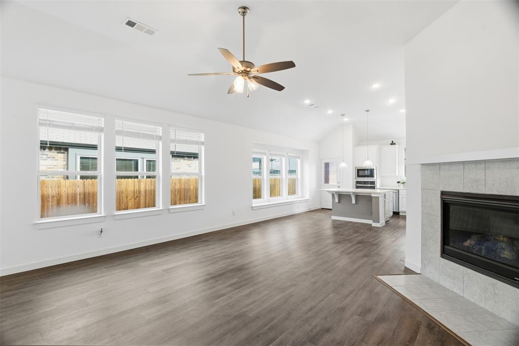 3910 Rochelle Lane Crandall, TX 75114 - Photo 12 of 32 a view of empty room with wooden floor and fireplace