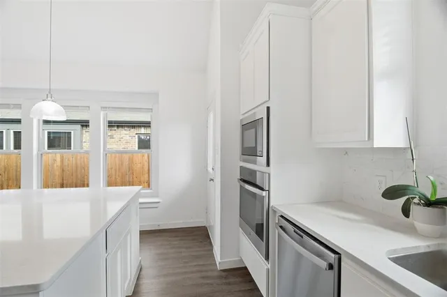 a kitchen that has a lot of cabinets in it