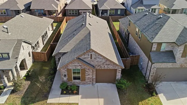 an aerial view of residential houses with outdoor space