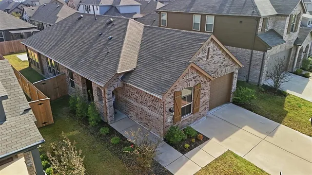 an aerial view of a house with a yard