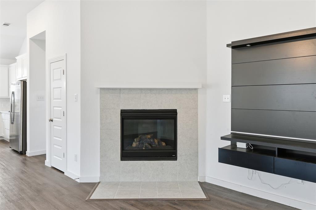 3910 Rochelle Lane Crandall, TX 75114 - Photo 9 of 32 a living room with a fireplace
