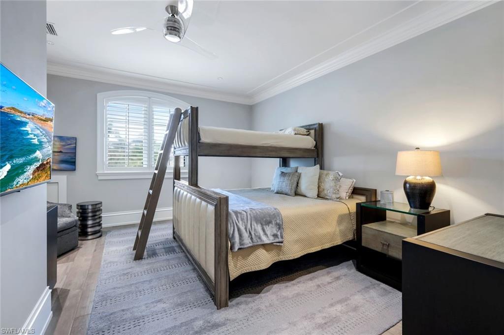 350 Springline Drive Naples, FL 34102 - Photo 21 of 33 Bedroom featuring crown molding, light wood finished floors, and a ceiling fan
