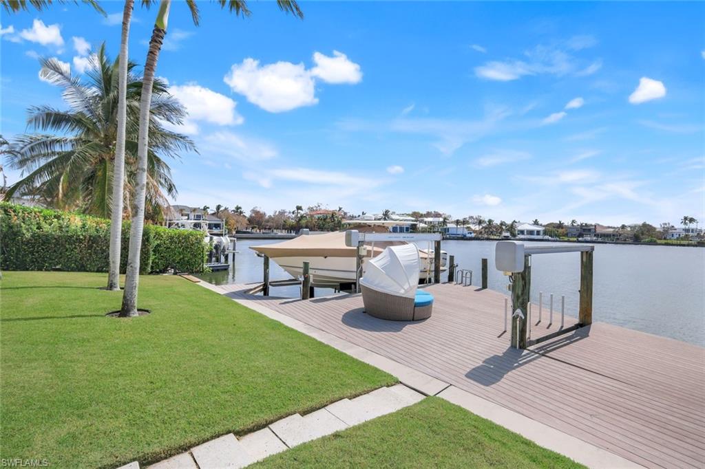 350 Springline Drive Naples, FL 34102 - Photo 24 of 33 Dock featuring a water view, boat lift, and a yard