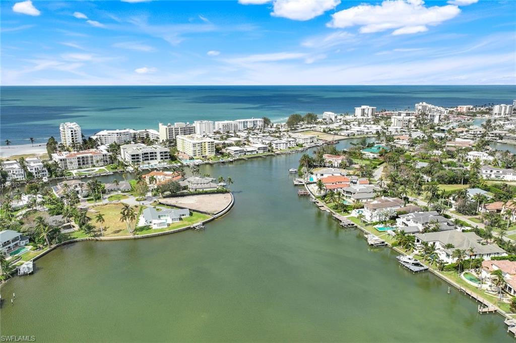 350 Springline Drive Naples, FL 34102 - Photo 31 of 33 Aerial view of property and surrounding area featuring a nearby body of water and nearby urban area