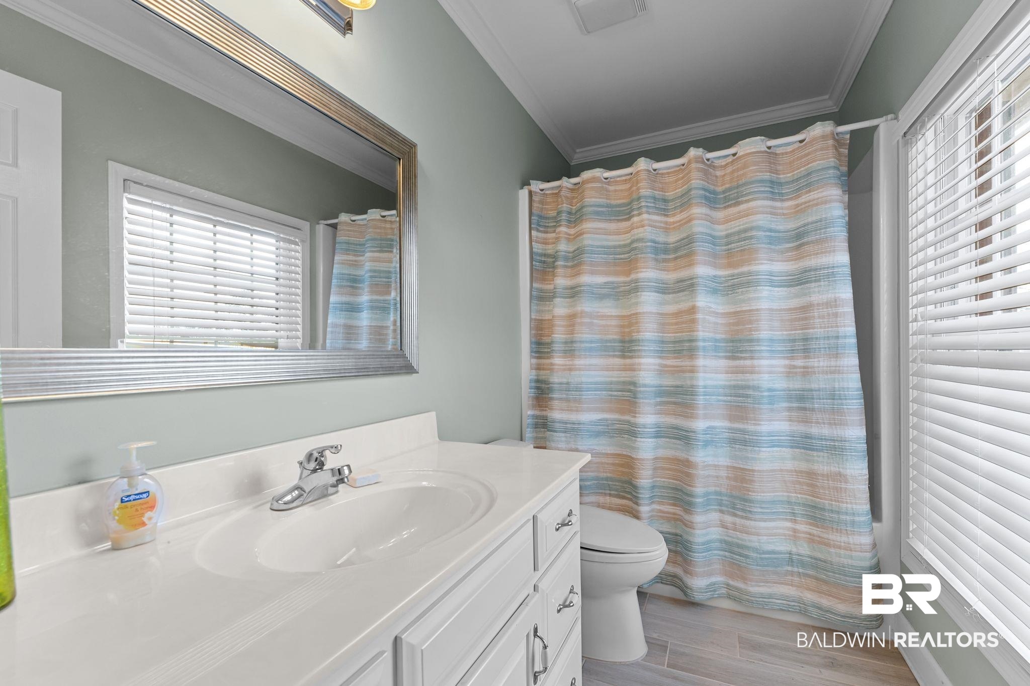 525 Norwood Road Monroeville, AL 36460 - Photo 33 of 55 Full bathroom with curtained shower, vanity, crown molding, and wood finish floors