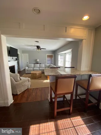 a living room with furniture and a dining table with kitchen view