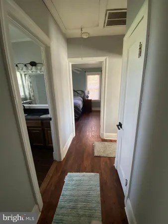 a view of a hallway view with wooden floor and staircase