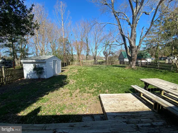 a view of a backyard with wooden fence