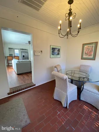 a living room with couches and painting on the wall