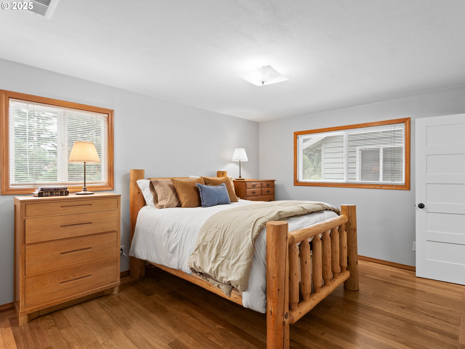 34603 Southeast Jarl Road Boring, OR 97009 - Photo 13 of 48 a bedroom with a bed and wooden floor