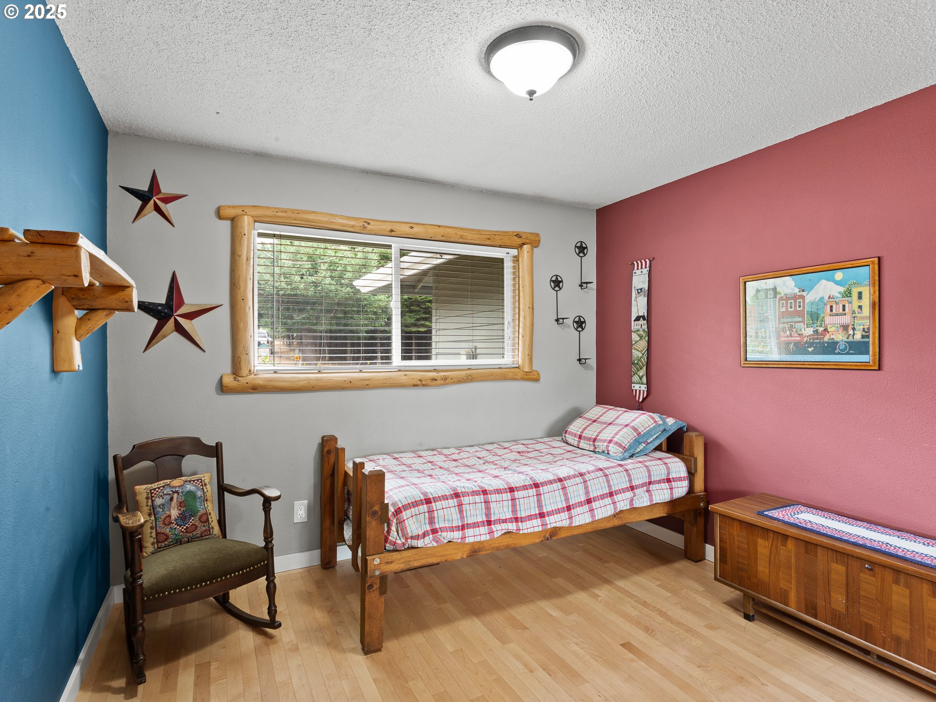 34603 Southeast Jarl Road Boring, OR 97009 - Photo 16 of 48 a bedroom with a bed and wooden floor