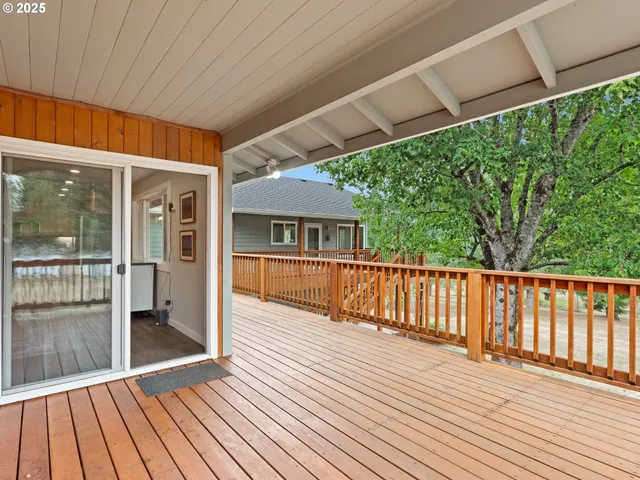 a view of backyard with a deck and wooden floor