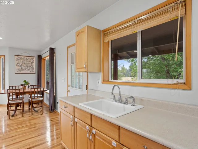 a large kitchen with stainless steel appliances granite countertop a stove and a sink