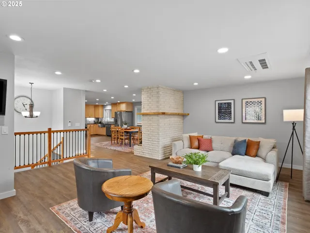 a living room with furniture a rug and a chandelier