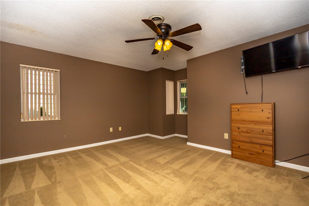 1302 Leeward Road Anderson, SC 29625 - Photo 23 of 50 A comfortable bedroom with rich brown walls and plush carpeting, perfect for relaxation.