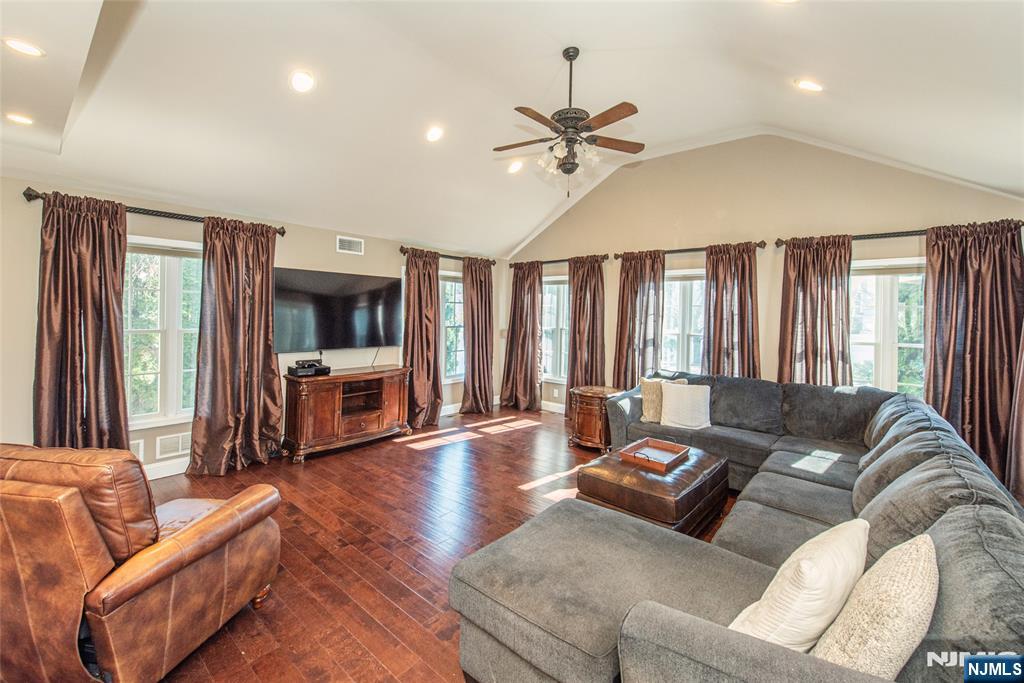 18 Stonycroft Road Wayne, NJ 07470 - Photo 13 of 40 a living room with furniture and a flat screen tv with kitchen view