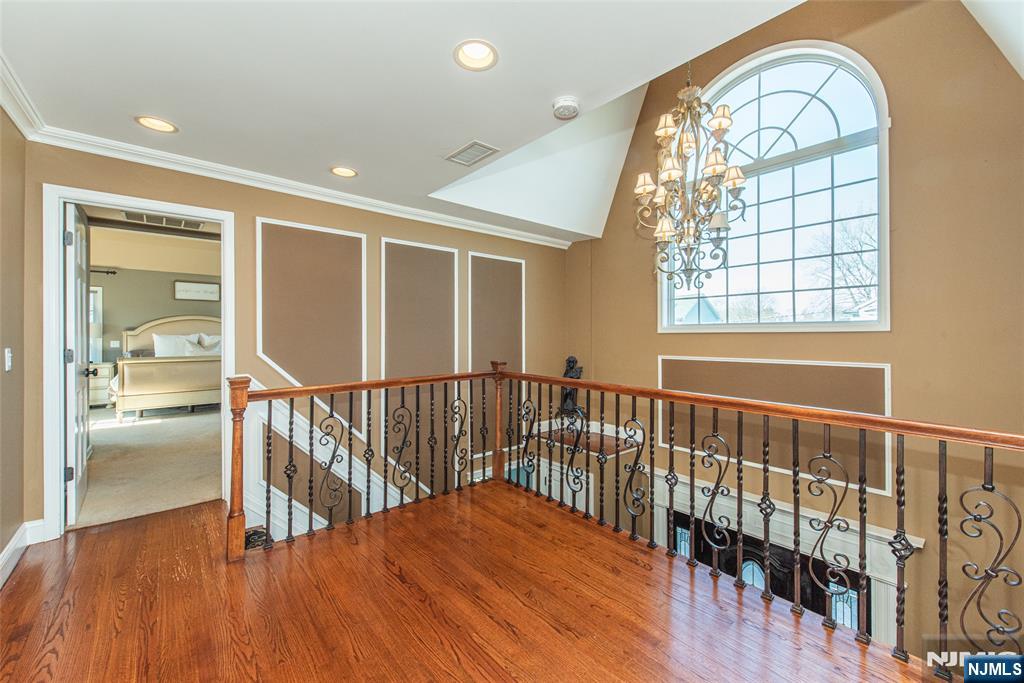 18 Stonycroft Road Wayne, NJ 07470 - Photo 25 of 40 an empty room with wooden floor windows and a chandelier