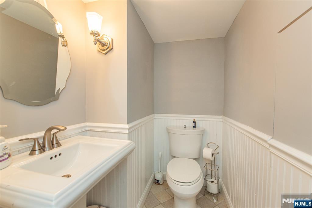 18 Stonycroft Road Wayne, NJ 07470 - Photo 29 of 40 a bathroom with a sink mirror and toilet