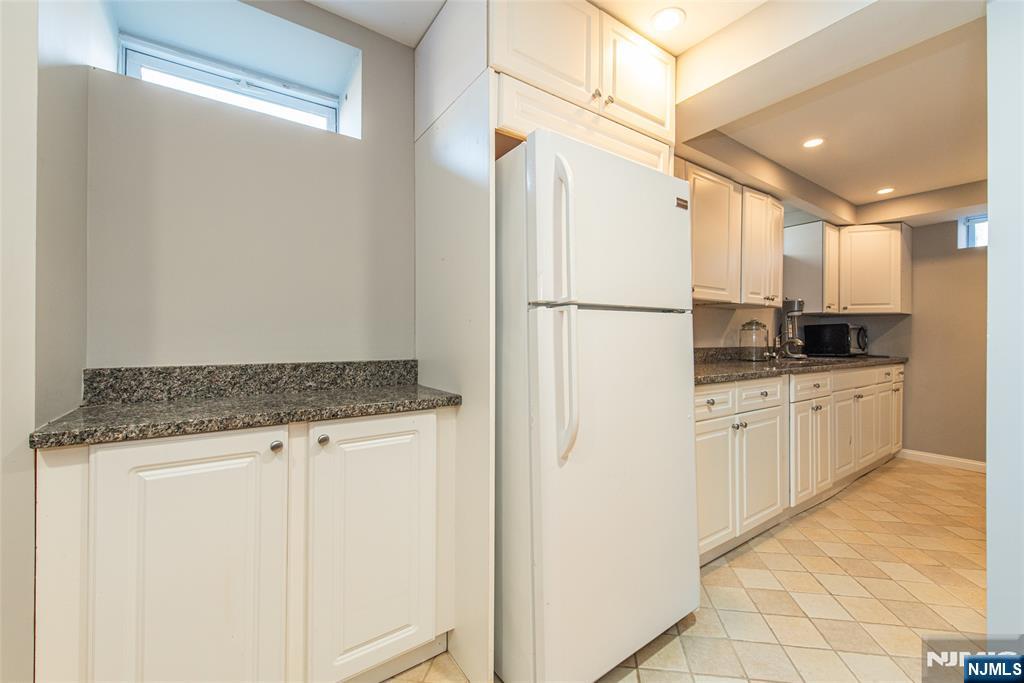 18 Stonycroft Road Wayne, NJ 07470 - Photo 31 of 40 a kitchen with white cabinets and white appliances