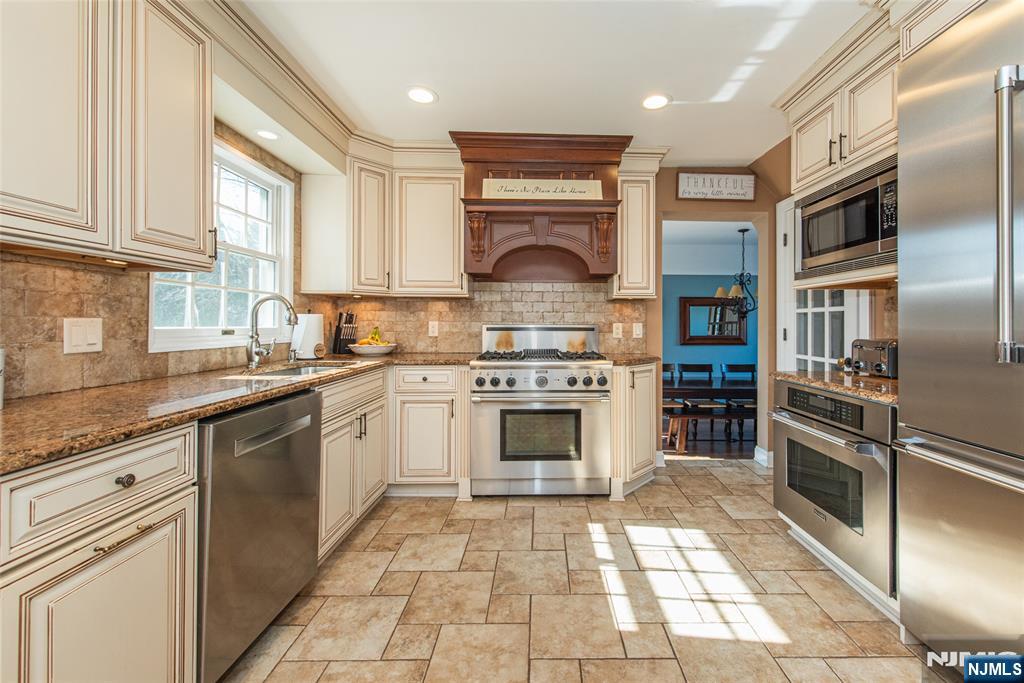 18 Stonycroft Road Wayne, NJ 07470 - Photo 8 of 40 a kitchen with a sink stove and cabinets