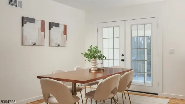 a dining room with furniture and wooden floor
