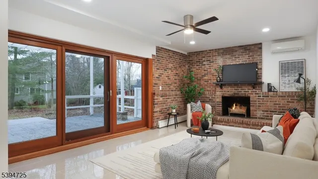 a living room with furniture a large window and a fireplace