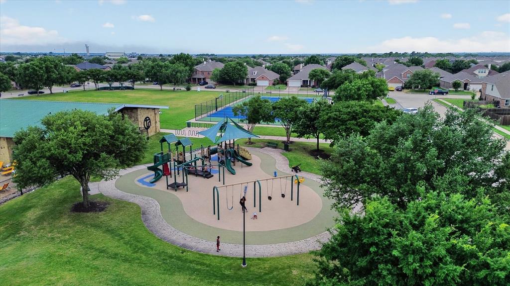 2428 Rosharon Drive Forney, TX 75126 - Photo 34 of 40 Community park with a playground, open green space, tennis courts, and a covered pavilion