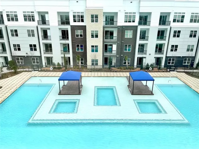 a dinning area with chandelier and kitchen view