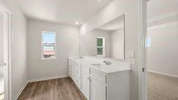 a bathroom with a sink a mirror and a window