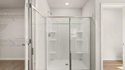 a bathroom with a glass shower door