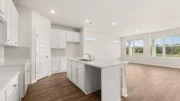 a kitchen with stainless steel appliances granite countertop a sink a stove and a refrigerator