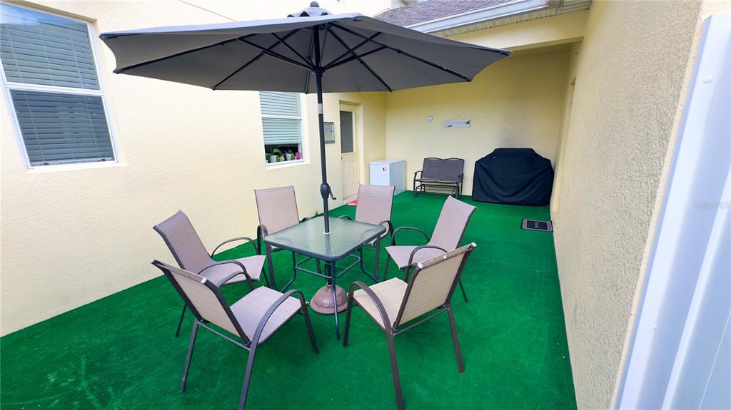 1217 Seburn Road Apopka, FL 32703 - Photo 20 of 61 a view of an outdoor sitting area with furniture and a umbrella