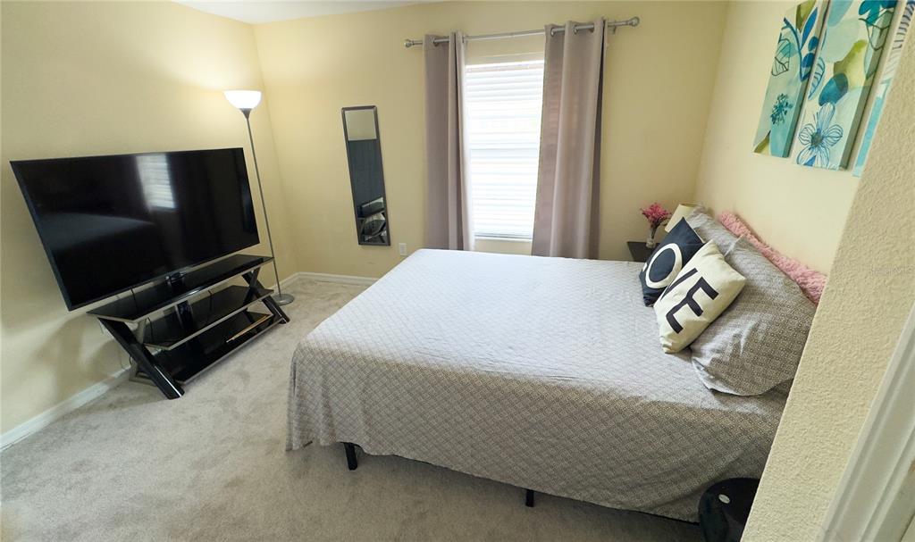 1217 Seburn Road Apopka, FL 32703 - Photo 25 of 61 a bedroom with a bed and flat screen tv