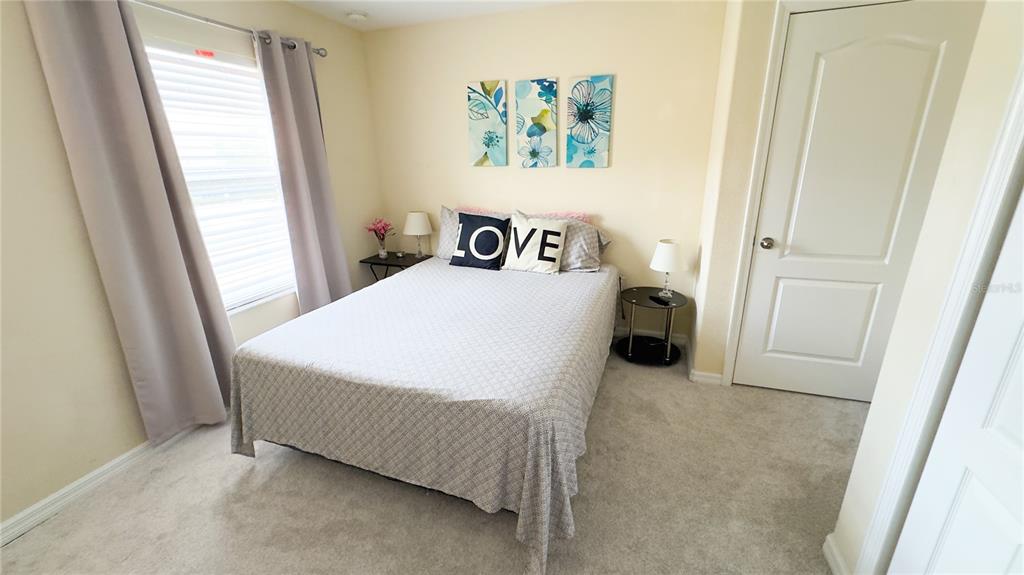 1217 Seburn Road Apopka, FL 32703 - Photo 26 of 61 a bedroom with a bed and a window