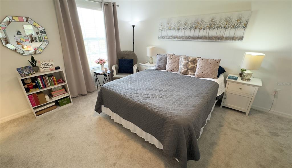 1217 Seburn Road Apopka, FL 32703 - Photo 28 of 61 a bedroom with a bed and a chandelier