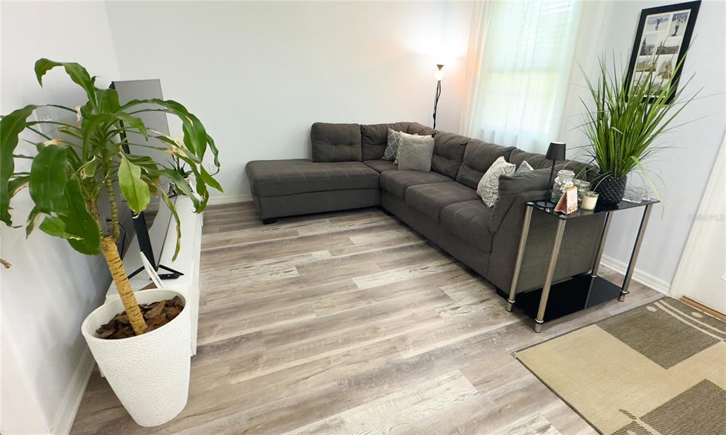 1217 Seburn Road Apopka, FL 32703 - Photo 34 of 61 a living room with furniture flowerpot and wooden floor