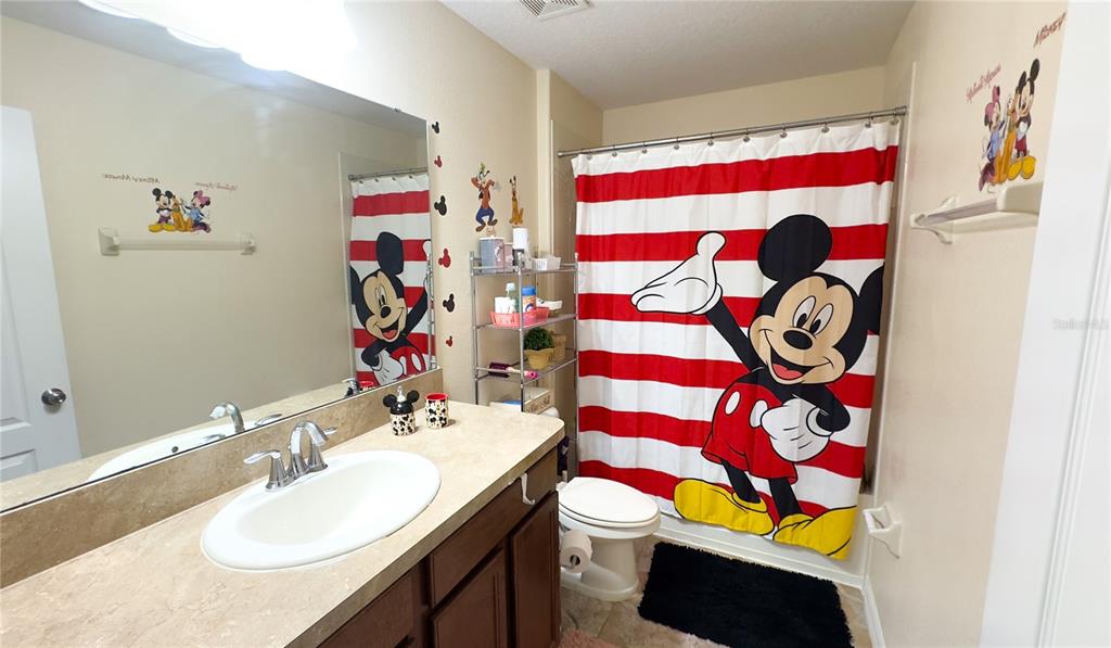 1217 Seburn Road Apopka, FL 32703 - Photo 49 of 61 a bathroom with a sink a toilet and curtain