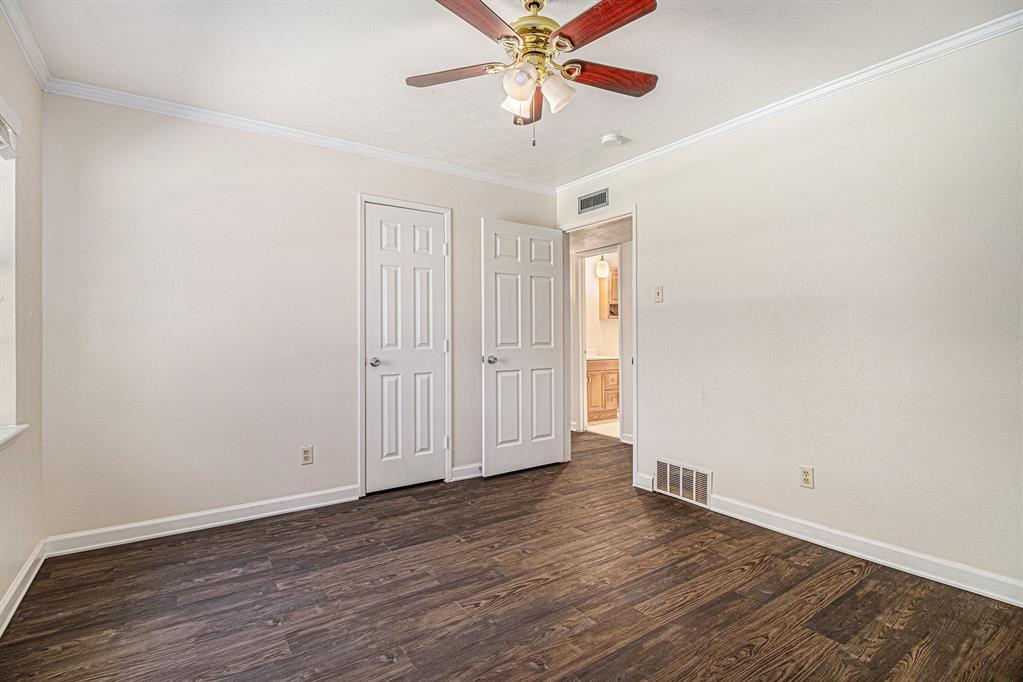 1814 Addington Drive Carrollton, TX 75007 - Photo 18 of 24 Empty room with dark hardwood / wood-style floors, ornamental molding, and ceiling fan