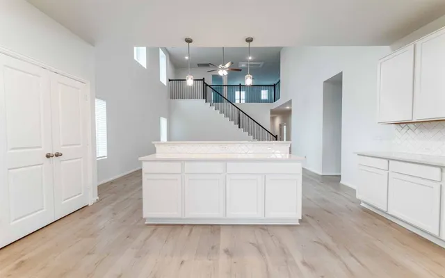 a view of entryway and kitchen with wooden floor