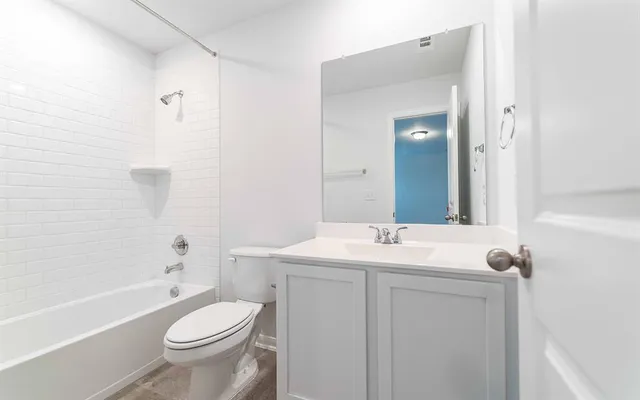 a bathroom with a toilet a sink and a bathtub