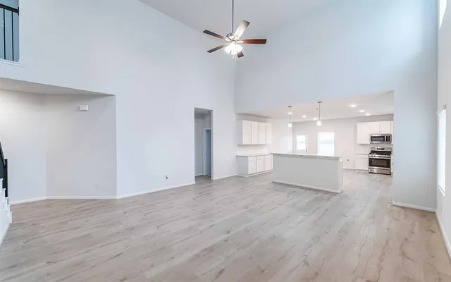 a view of a kitchen with wooden floor and a kitchen