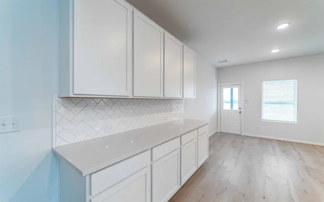 a view of a kitchen with wooden floor