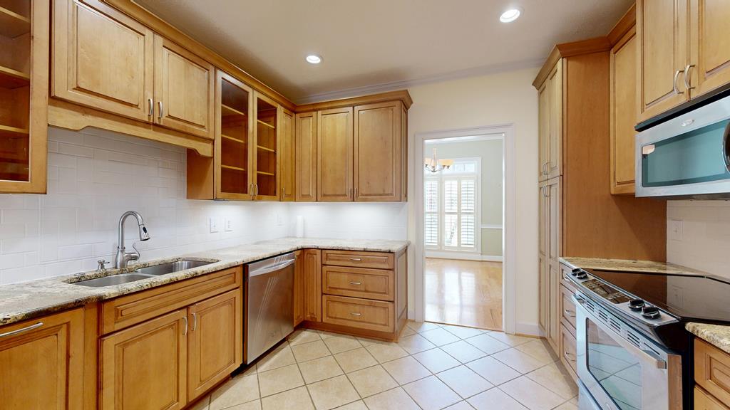 4608 Baltusrol Court Columbus, GA 31909 - Photo 17 of 76 a kitchen with stainless steel appliances granite countertop a sink and a stove