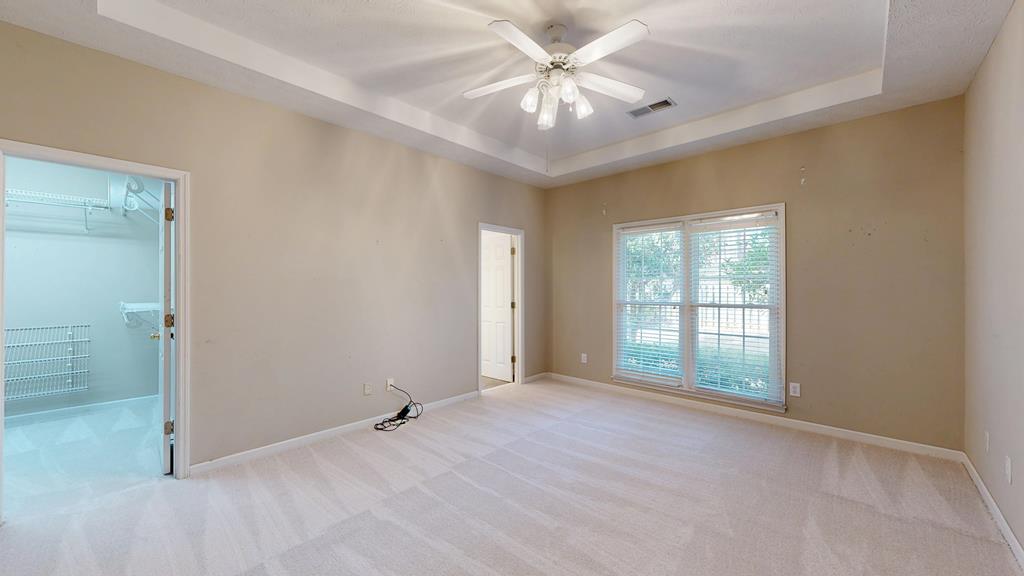 4608 Baltusrol Court Columbus, GA 31909 - Photo 24 of 76 an empty room with chandelier fan and windows