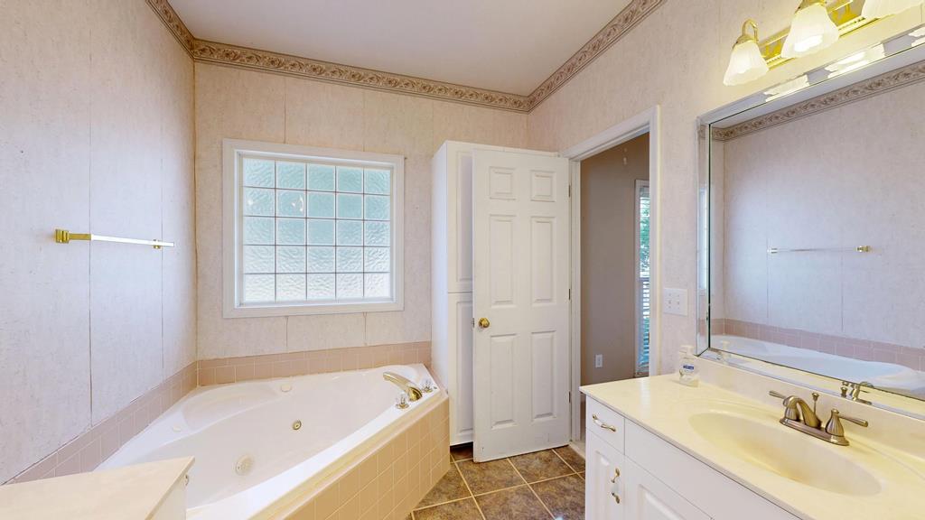 4608 Baltusrol Court Columbus, GA 31909 - Photo 30 of 76 a bathroom with a tub sink and mirror