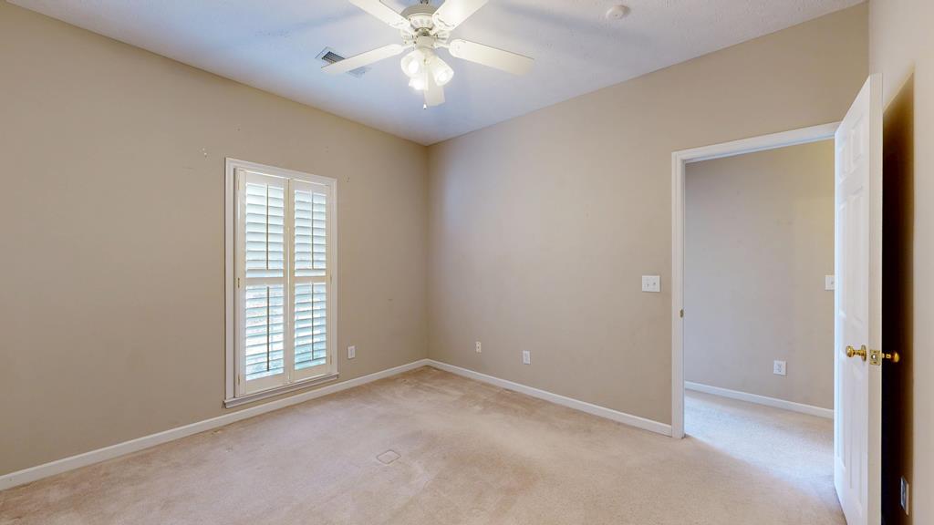 4608 Baltusrol Court Columbus, GA 31909 - Photo 57 of 76 an empty room with windows and chandelier fan