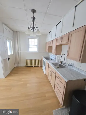 a kitchen with stainless steel appliances granite countertop a sink stove and white cabinets