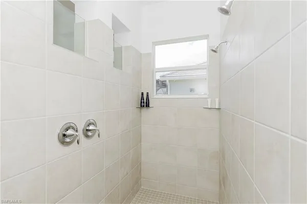 a large white bed in a white room