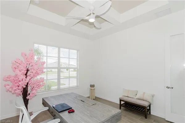a living room with furniture and a large window with balcony view